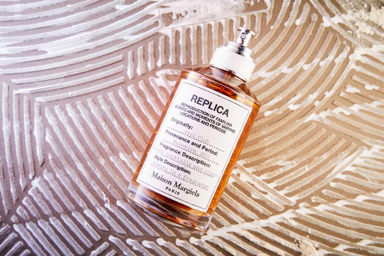 Maison Margiela 'Replica' Jazz Club Eau de Parfum displayed on a patterned brown surface