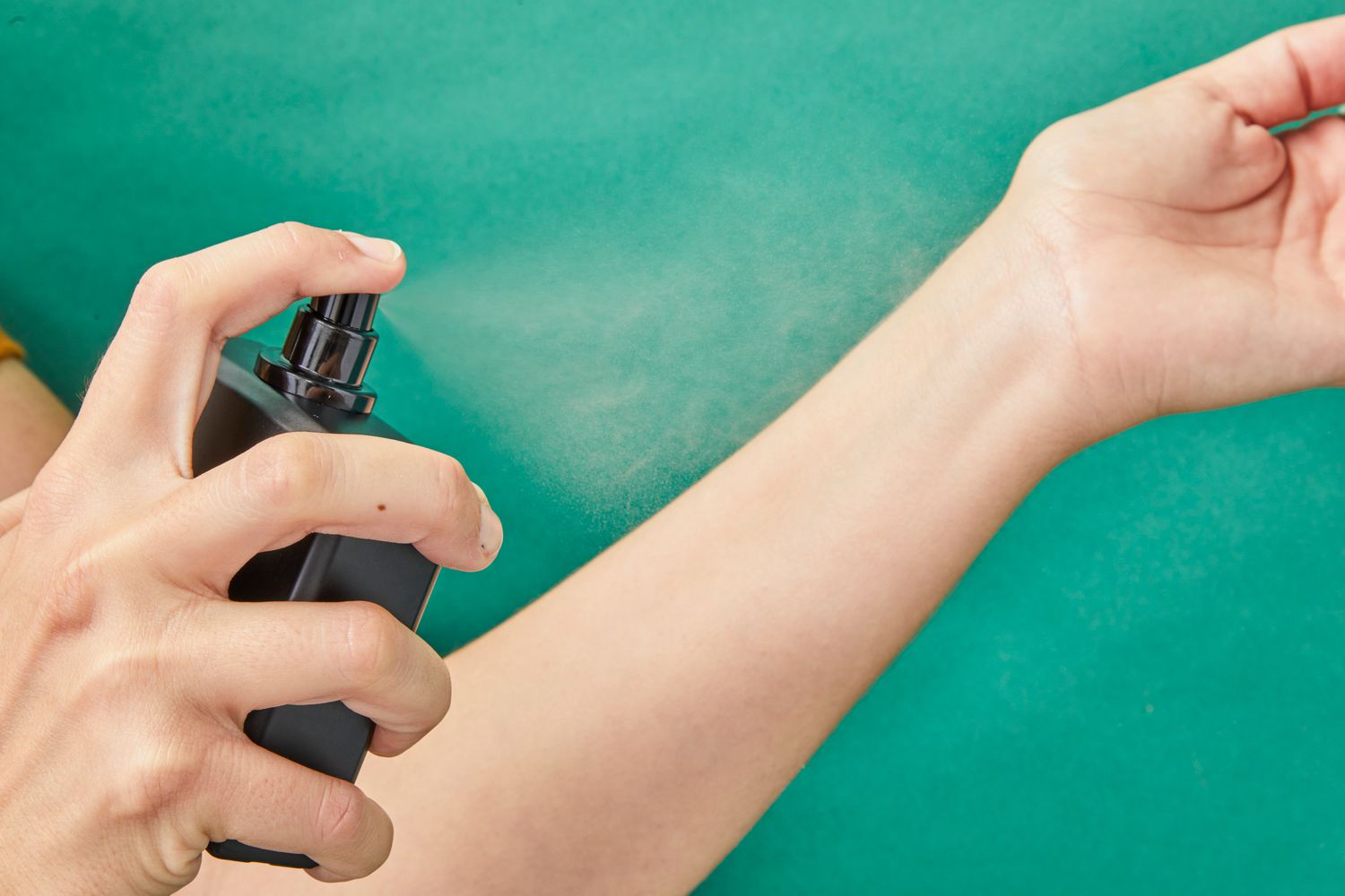 A person spraying Blu Atlas Atlantis Eau de Parfum on a wrist